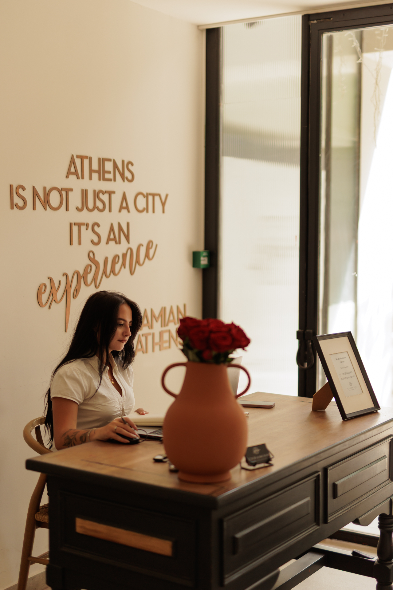 Ceramian Athens concierge desk with Athens is not just a city, it is an experience signage