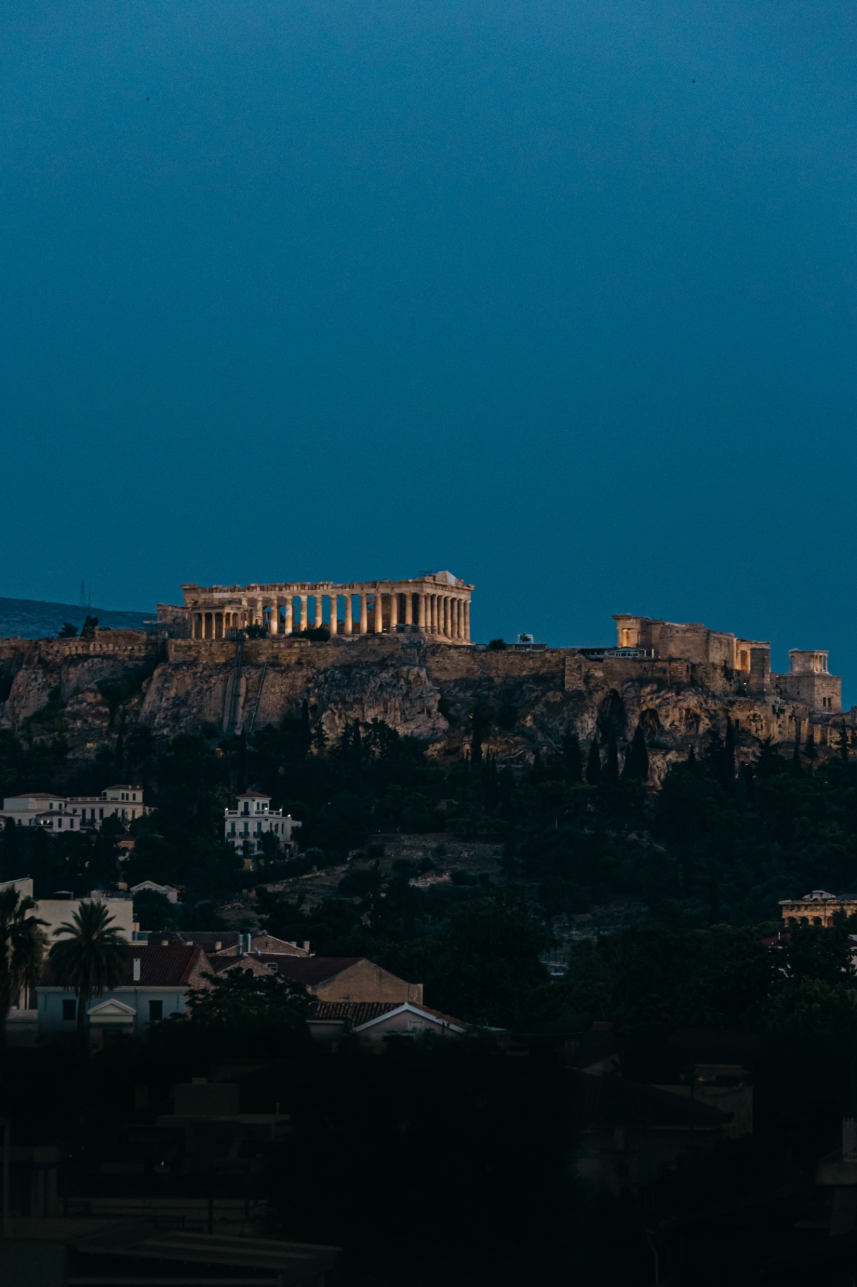 The Acropolis illuminated at twilight over Athens