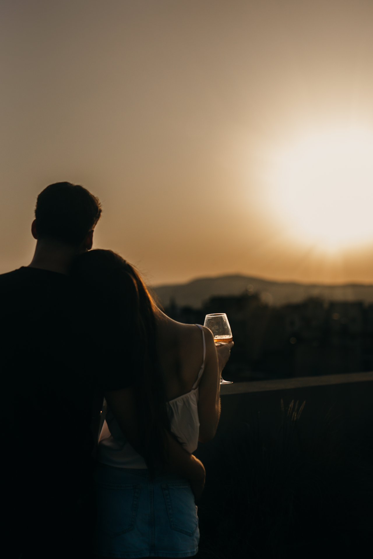 Couple leaning together watching the Athens sunset